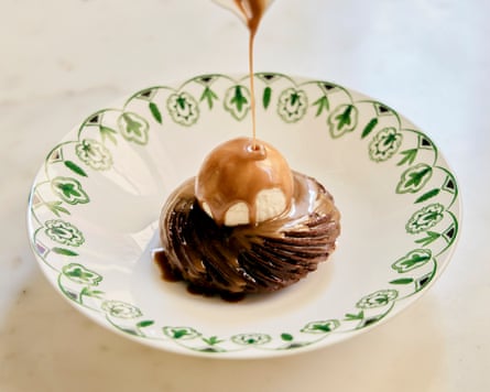Sticky toffee being poured on to Dante Mayfair's sticky toffee doughnut with whisky flambé.