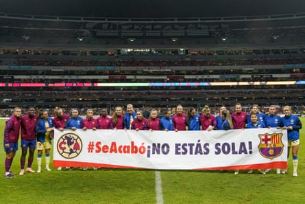Players of América and Barcelona hold a banner in support of Jennifer Hermoso, before a friendly in Mexico City.