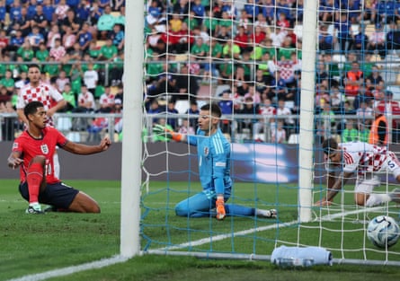 Jude Bellingham slots the ball past Dominik Livakovic to score EnglandâÂÂs second goal.