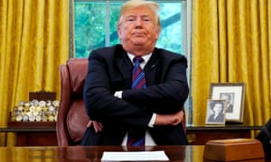 President Trump sits behind his desk