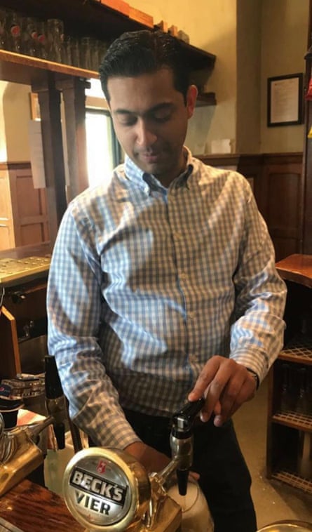 Laurence D’Lima pulls a pint of Becks in his pub, the Queen’s Head.