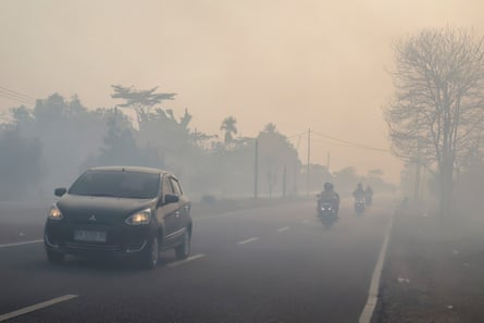 Traffic on a haze-shrouded road in Palangka Raya city, Central Kalimantan, on 20 August 2026.
