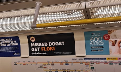 A Floki Inu cryptocurrency advert on a London Underground train.