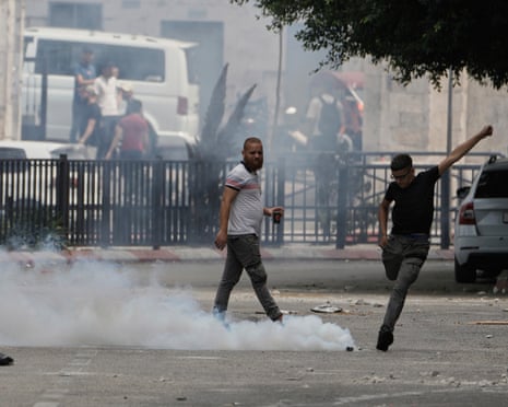 A Palestinian kicks a teargas canister during an Israeli military raid in the West Bank city of Nablus on Wednesday, 27 August 2025. qhiukiqrihuinv