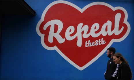 People walk past a pro-choice mural in Dublin ahead of the 25 May referendum on repealing the eighth amendment in the Irish constitution, which bans abortion.