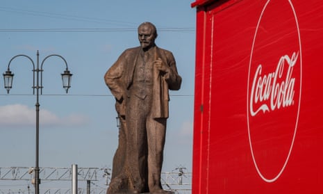 A truck passes a monument to Lenin in Moscow