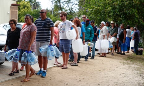Residents queue to collect drinking water from a mountain spring collection point last month.