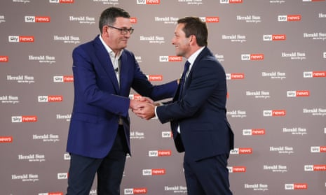 Victorian premier Daniel Andrews shakes hands with opposition leader Matthew Guy, as both men smile