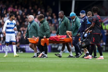 Massimo Luongo is taken off injured during Millwall’s win at QPR.