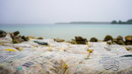 A seawall built from rice bags filled with coral and shells on Torotsian Island.