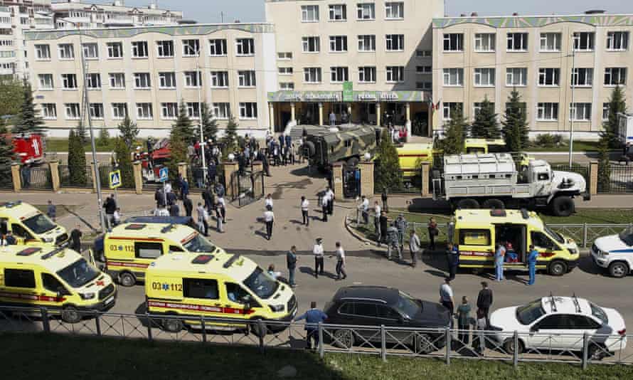 Ambulances and police vehicles outside the school in Kazan, Russia