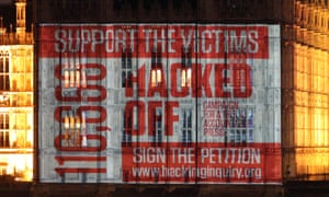 A Hacked Off message projected onto parliament