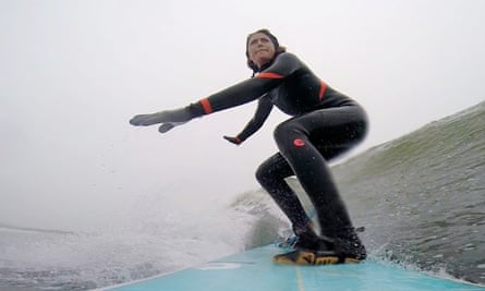 Grace Lee, a vice president at a civil engineering firm in downtown Manhattan, rides a wave at Rockaway Beach.