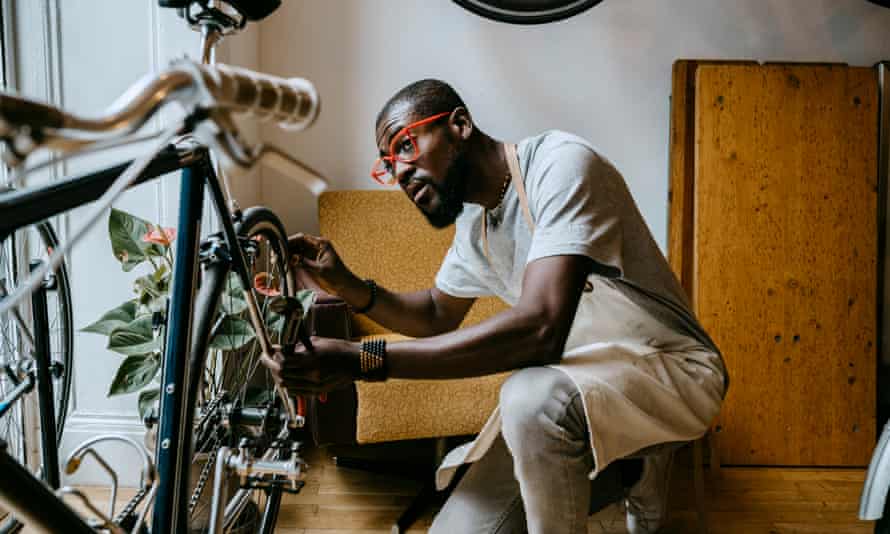 Male owner repairing bicycle in workshop