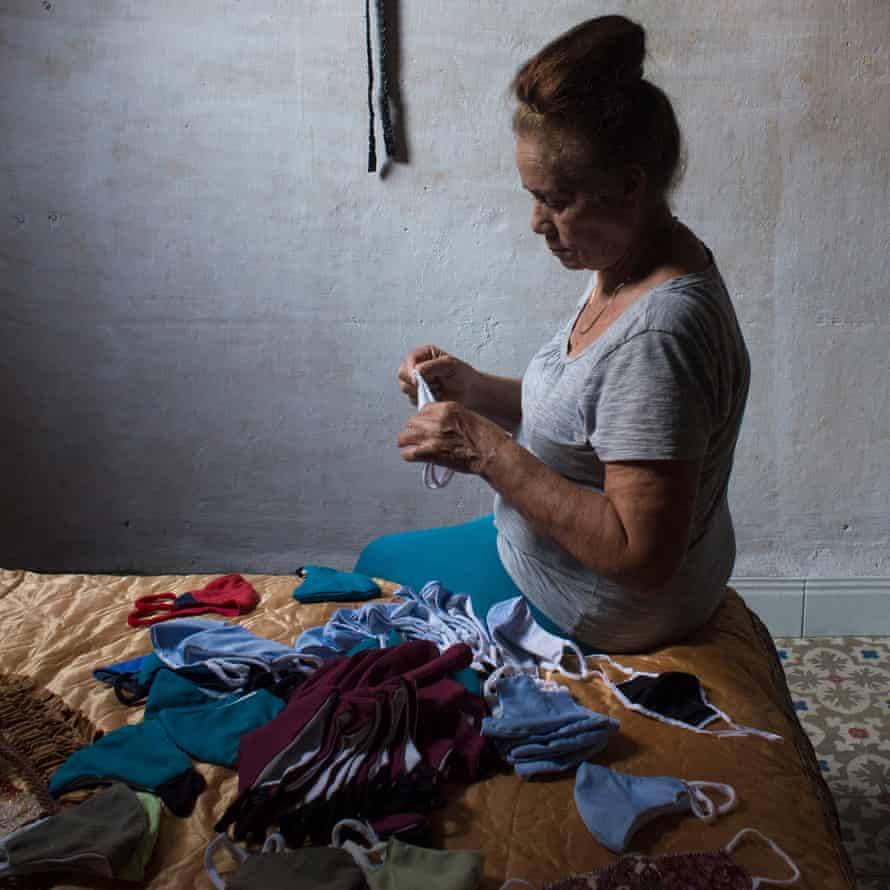 A retired woman works as a seamstress to make a living