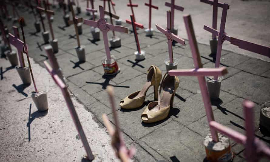 High heel shoes are seen in front of a cross outside the Municipal Palace of Ecatepec during a protest against femicides.
