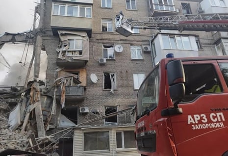 Firefighters are among rescue workers at the scene in Zaporizhzhia.