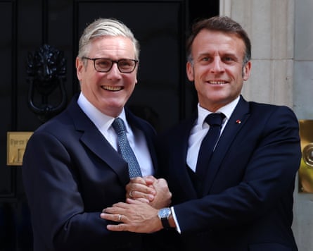 Keir Starmer and Emmanuel Macron in a warm handclasp outside No 10