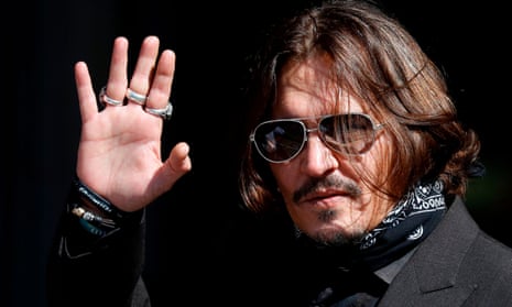 Johnny Depp waves outside the high court in London.