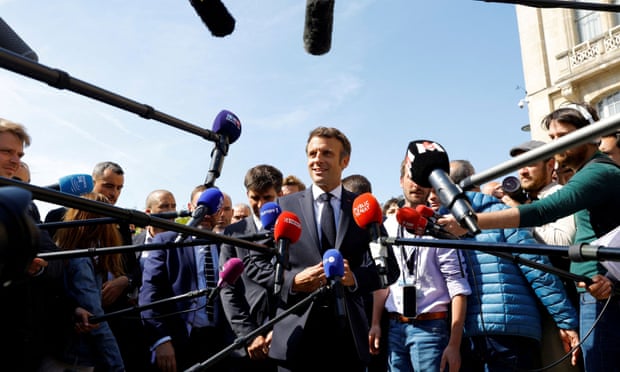 Emmanuel Macron speaks to the media during a visit to Saint-Denis