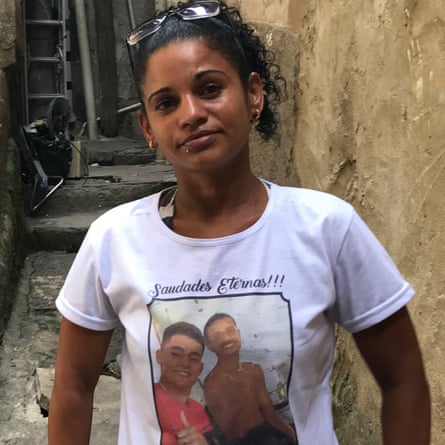 Eline Vicente da Silva, 36, in Fallet/Fogueteiro. Her sons David, 22, and Maikon, 16, were killed on Friday and their photos are on her T-shirt.