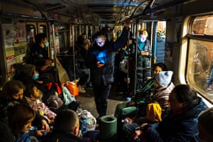 Hundreds of people seek shelter underground, on the platform, inside the dark train cars in Kharkiv