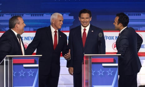 Chris Christie (left) Mike Pence (second from left), Ron DeSantis (center right) and Vivek Ramaswamy (right) chat during a break in the first debate of the GOP primary season.