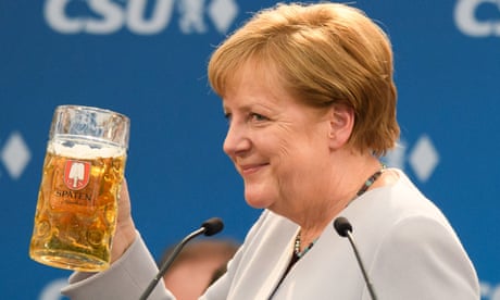 Angela Merkel holds a beer mug after a speech in Munich.