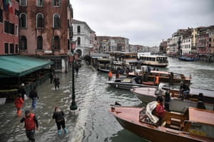 The flooded embankment by the Hotel Rialto (left) and the Grand Canal