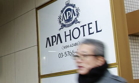 A man walks past the entrance of an APA hotel in Tokyo.