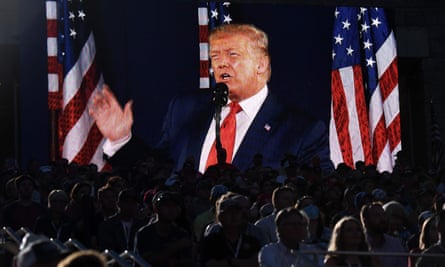 Donald Trump is shown on a screen as he speaks at Mount Rushmore.
