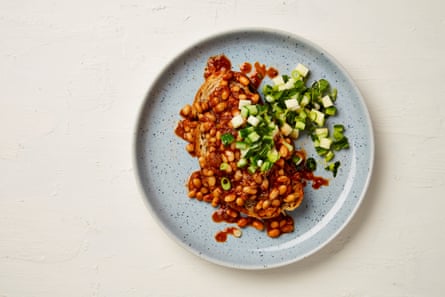A plate of spicy baked beans on toast with apple and cucumber salsa.