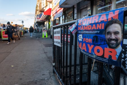 A campaign poster for New York City Mayor-elect Zohran Mamdani is displayed on a fence on November 06, 2025 in the Brooklyn borough of New York City. With the election of Zohran Mamdani as New York City’s next mayor, a new focus is being placed on the high cost of living in one of the world’s most expensive cities.