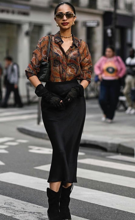 woman crosses street
