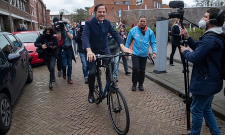 Rutte leaves on his bicycle after casting his general election vote in The Hague in 2021