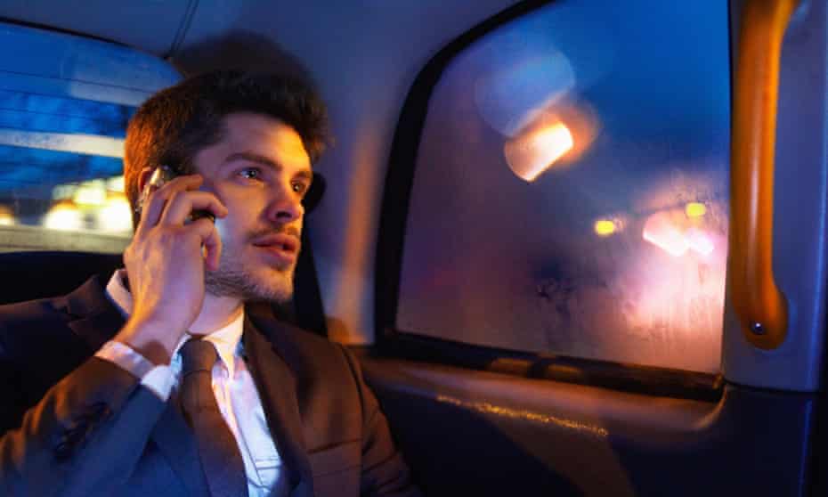 man on phone in taxi