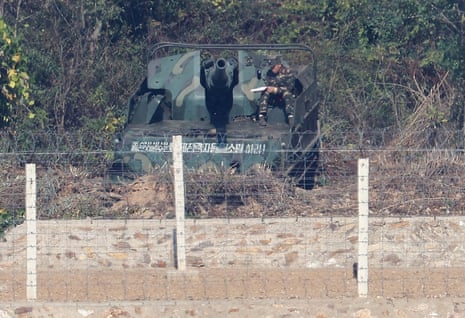 A North Korean soldier sits on a self-propelled howitzer deployed along the border separating the two Koreas on 27 October