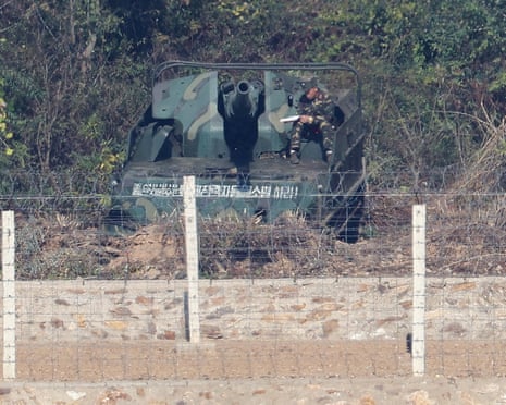 A North Korean soldier sits on a self-propelled howitzer deployed along the border separating the two Koreas on 27 October.