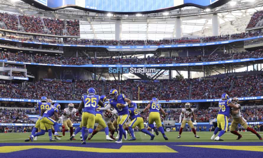 LA Rams' Matthew Stafford hands off to Sony Michel during the first half of the NFL football game against the San Francisco 49ers.