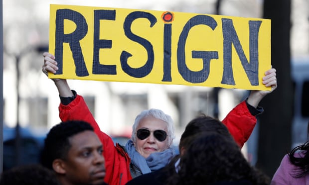 A demonstrator holds a sign during a protest to call for the resignation of Jeff Sessions on 2 March 2017 in Washington DC. 