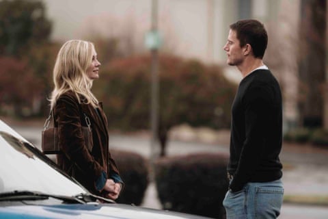 man and woman stand outside facing each other