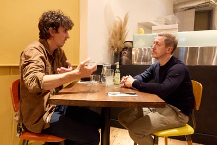Edward and Martin chatting at a restaurant table