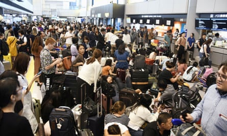 Passengers are stranded at Narita airport in Tokyo after railways and subway operators suspended their services following the passage of Typhoon Faxai.