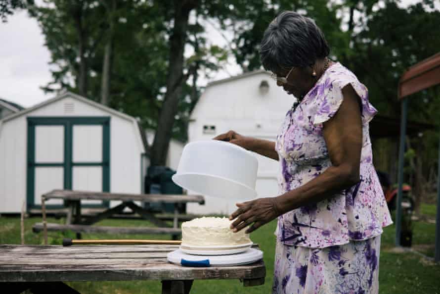 Suffolk, VA -- Catherine Jones preps a Father's Day cake to share with family in her backyard, which floods whenever heavy rain falls.