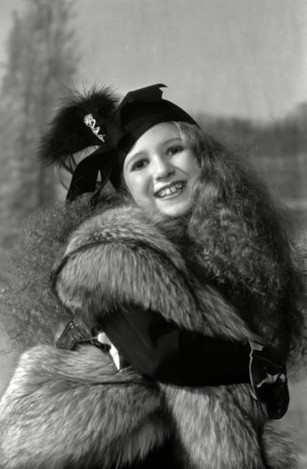 Langford dressed in furs and a black hat.
