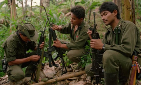 Rebels from the Revolutionary Armed Forces of Colombia (Farc) clean their rifles at a camp in the mountains near Miranda.