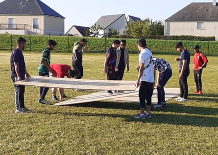 Players prepare the chipboard pitch.