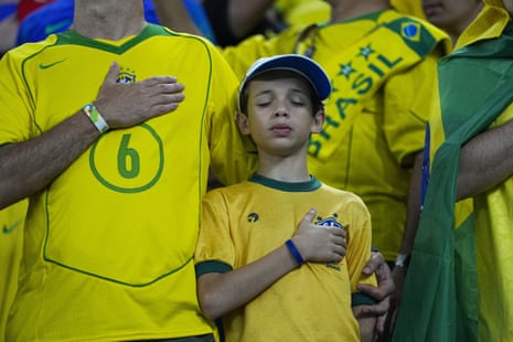 Brazilian fans listen to their national anthem,