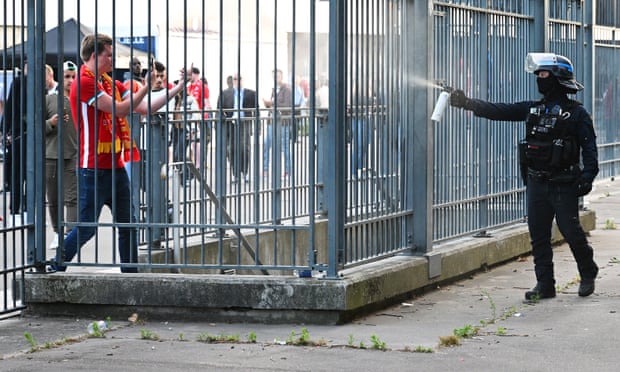 Teargas is sprayed by a police offer at the Champions League final.