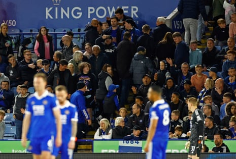 Leicester fans leave the stadium after Liverpool's Trent Alexander-Arnold scored his third goal.